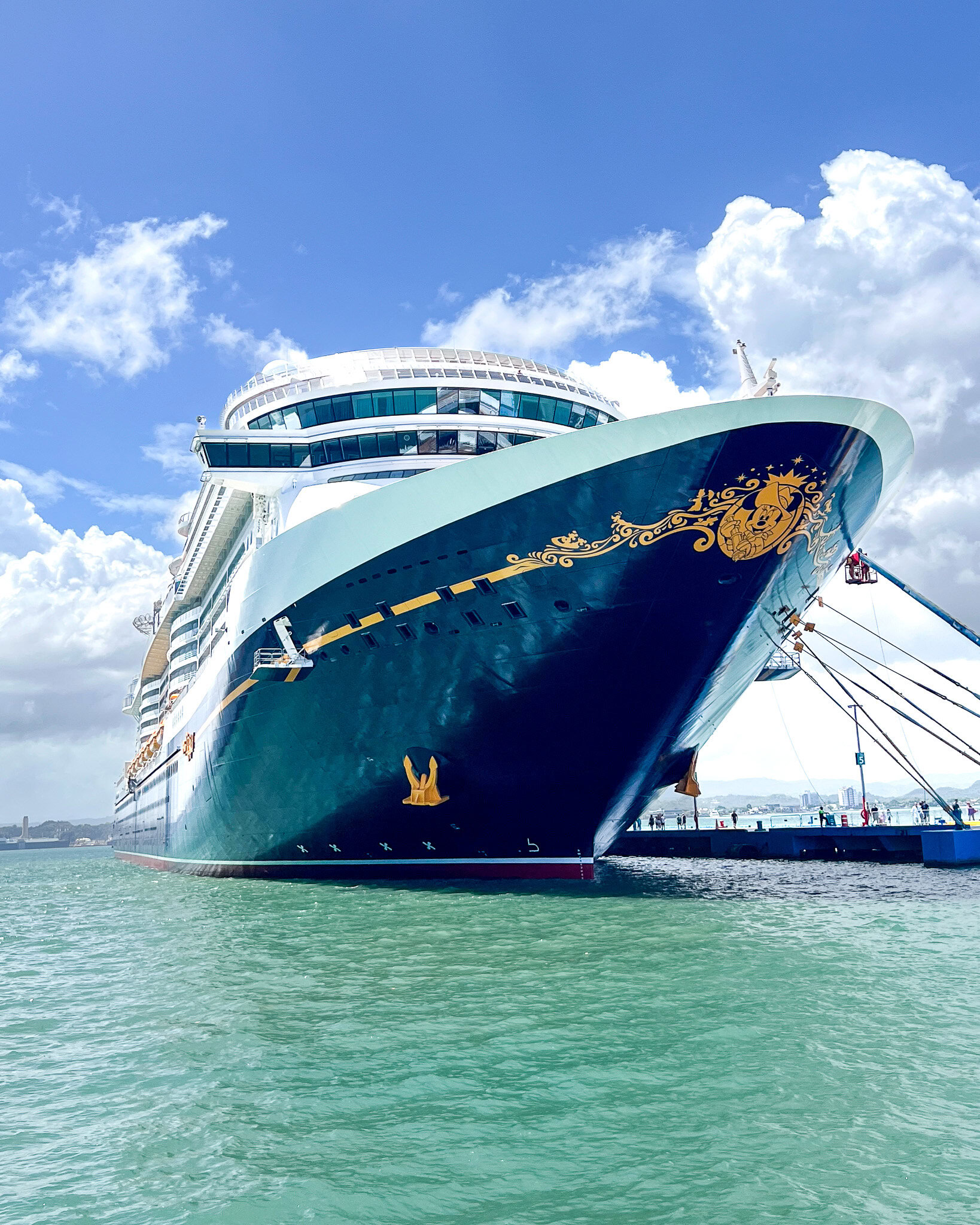 Disney Treasure Cruise Ship at Port Disney Treasure cruise ship docked at port under a bright blue sky