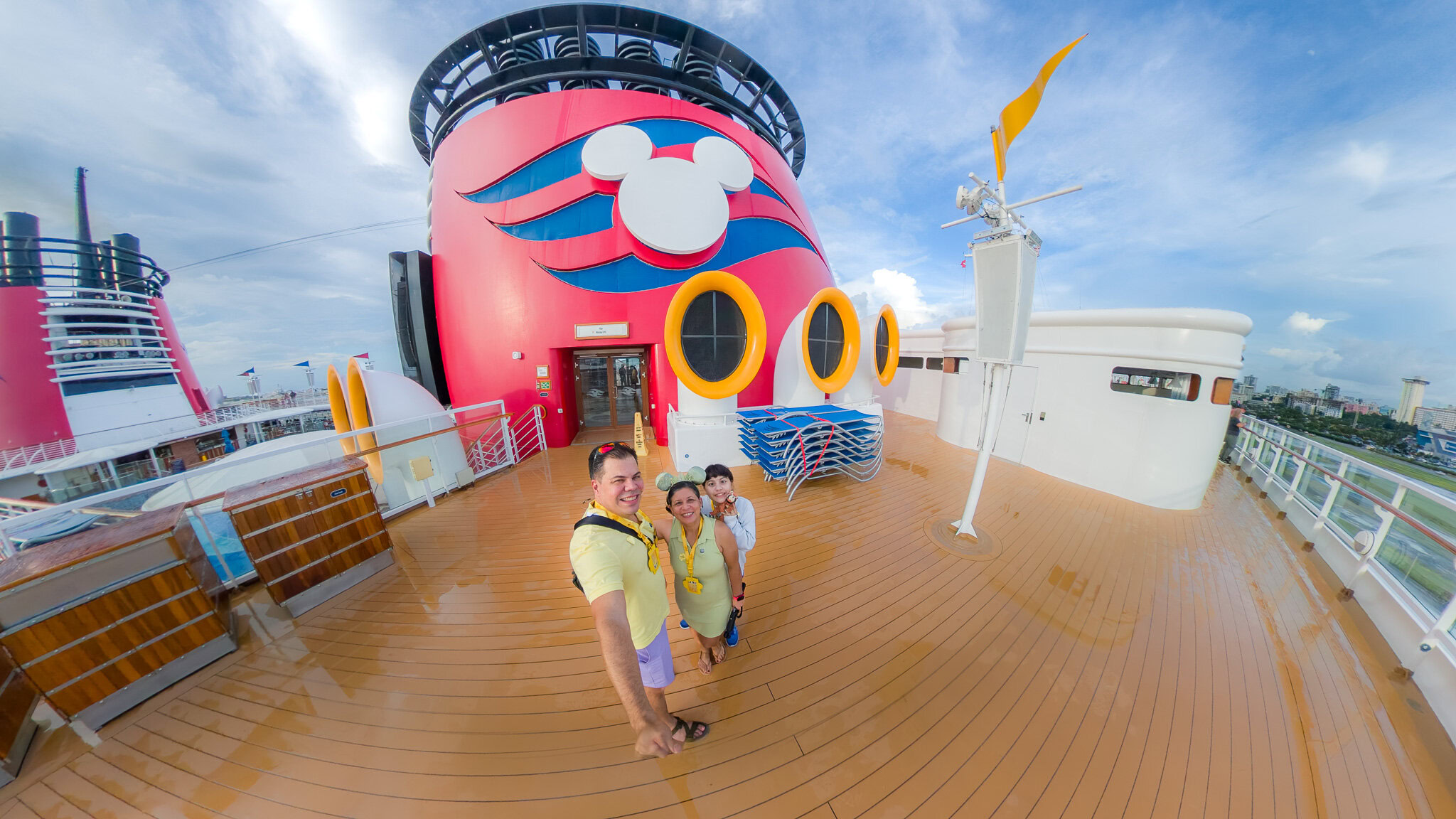 Raúl, Lucy, and Daniela on the Disney Magic deck during embarkation day for their Disney Cruise from San Juan Puerto Rico.