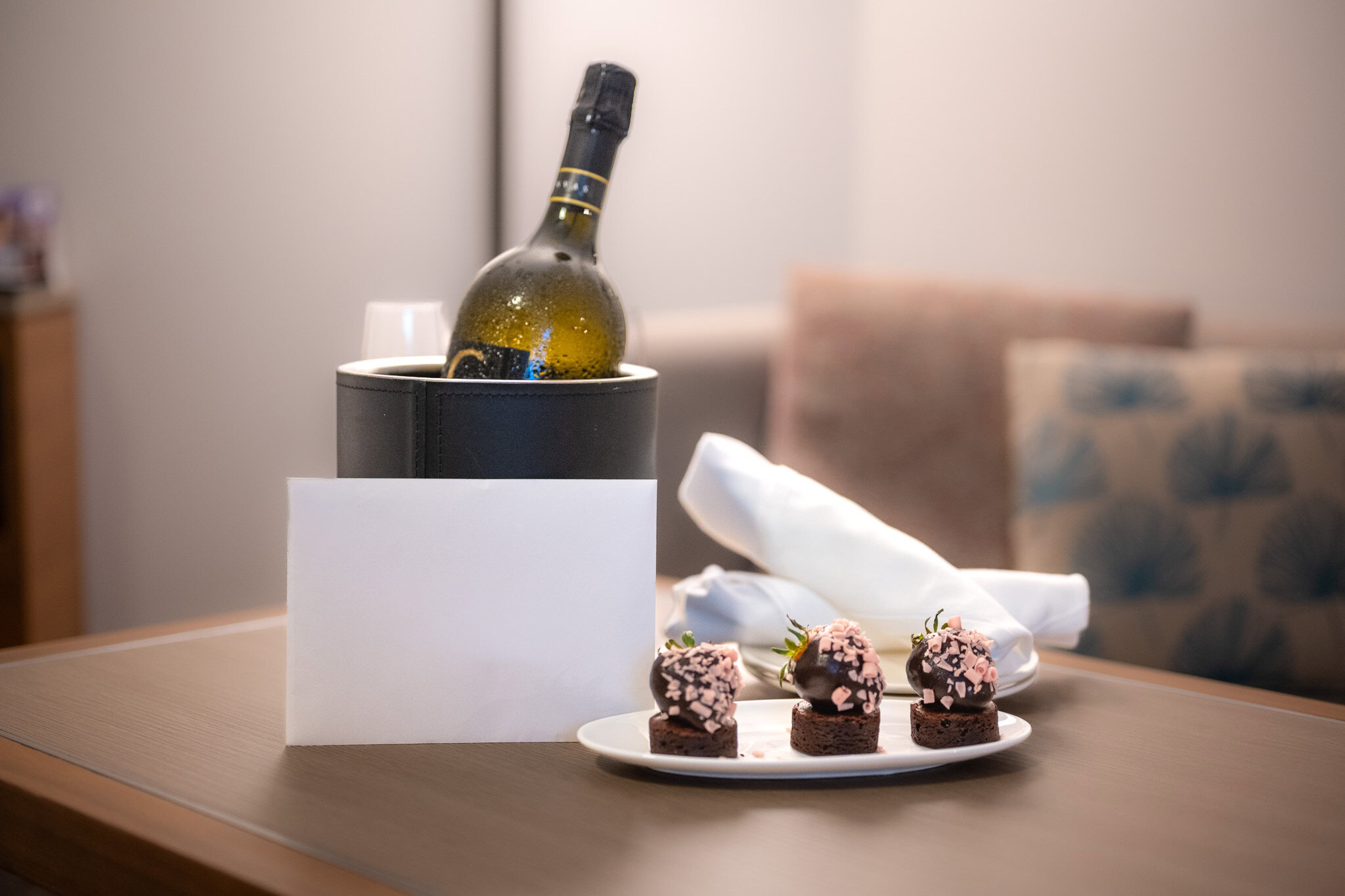 Luxury in-villa private dinner setup with chilled wine and chocolate-covered strawberries in Puerto Rico