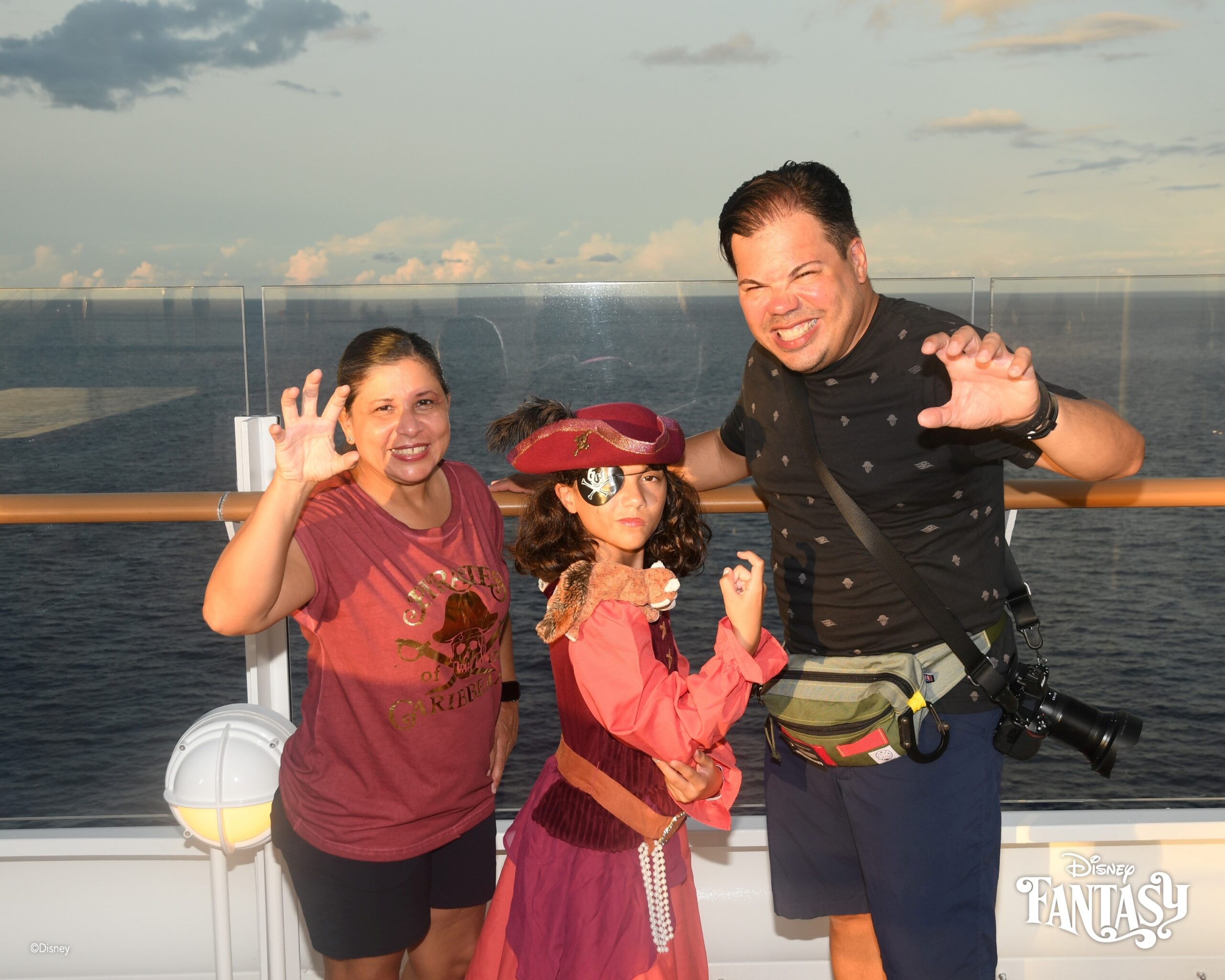 Daniela with Raúl and Lucy during Pirate Night on Disney Cruise deck with ocean view