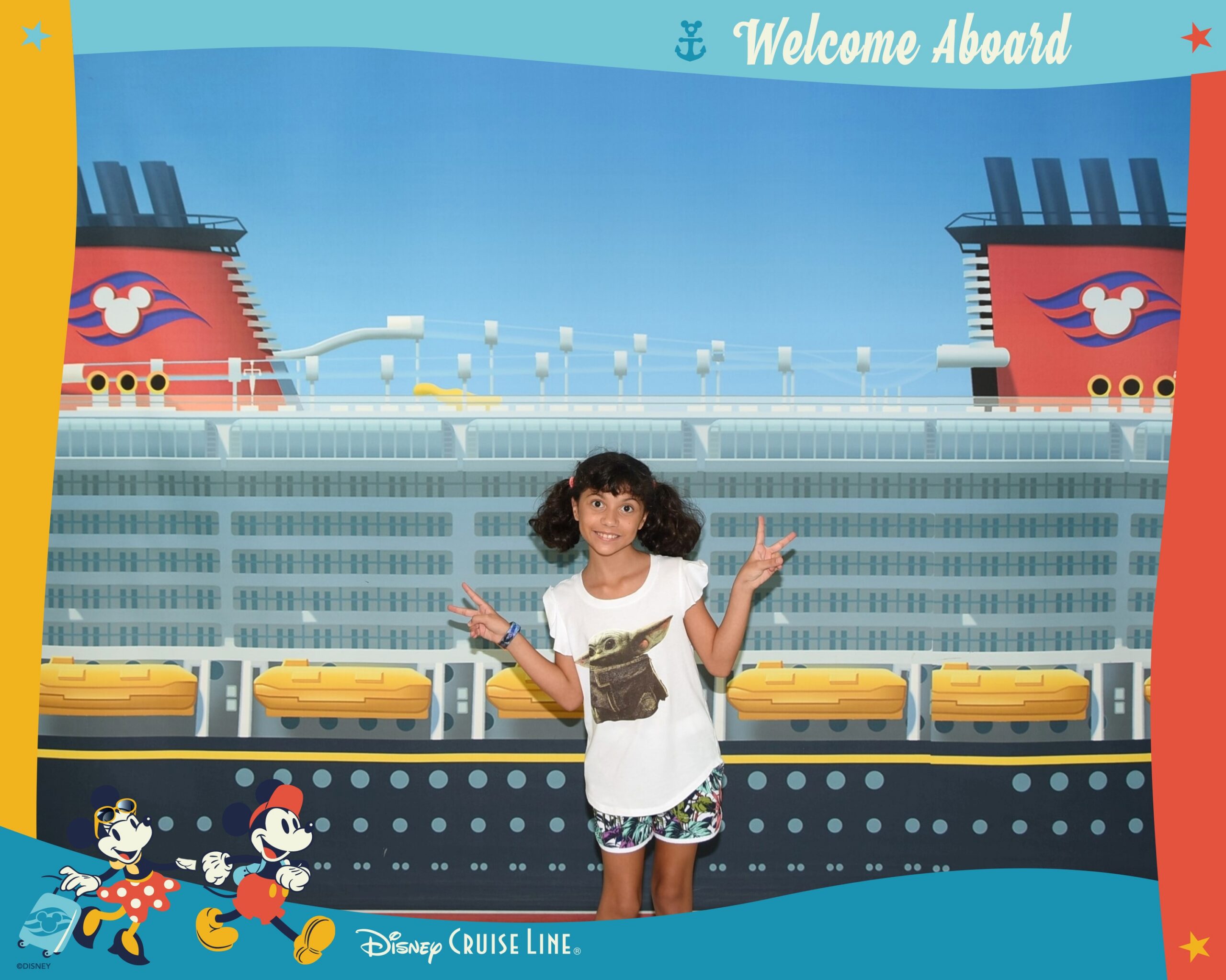 Daniela posing in front of Disney Cruise Line Welcome Aboard sign during embarkation