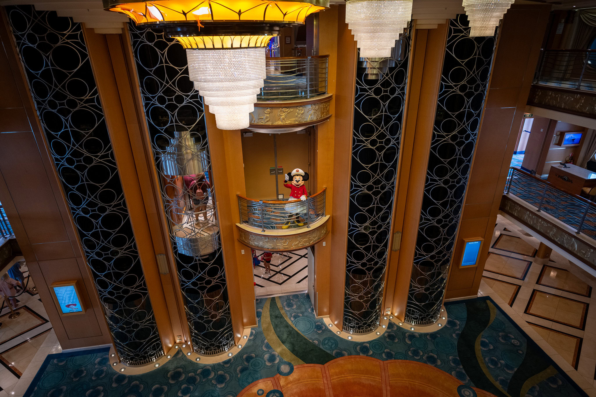 Captain Minnie in the Atrium – Disney Magic Captain Minnie waving from a balcony on Disney Magic