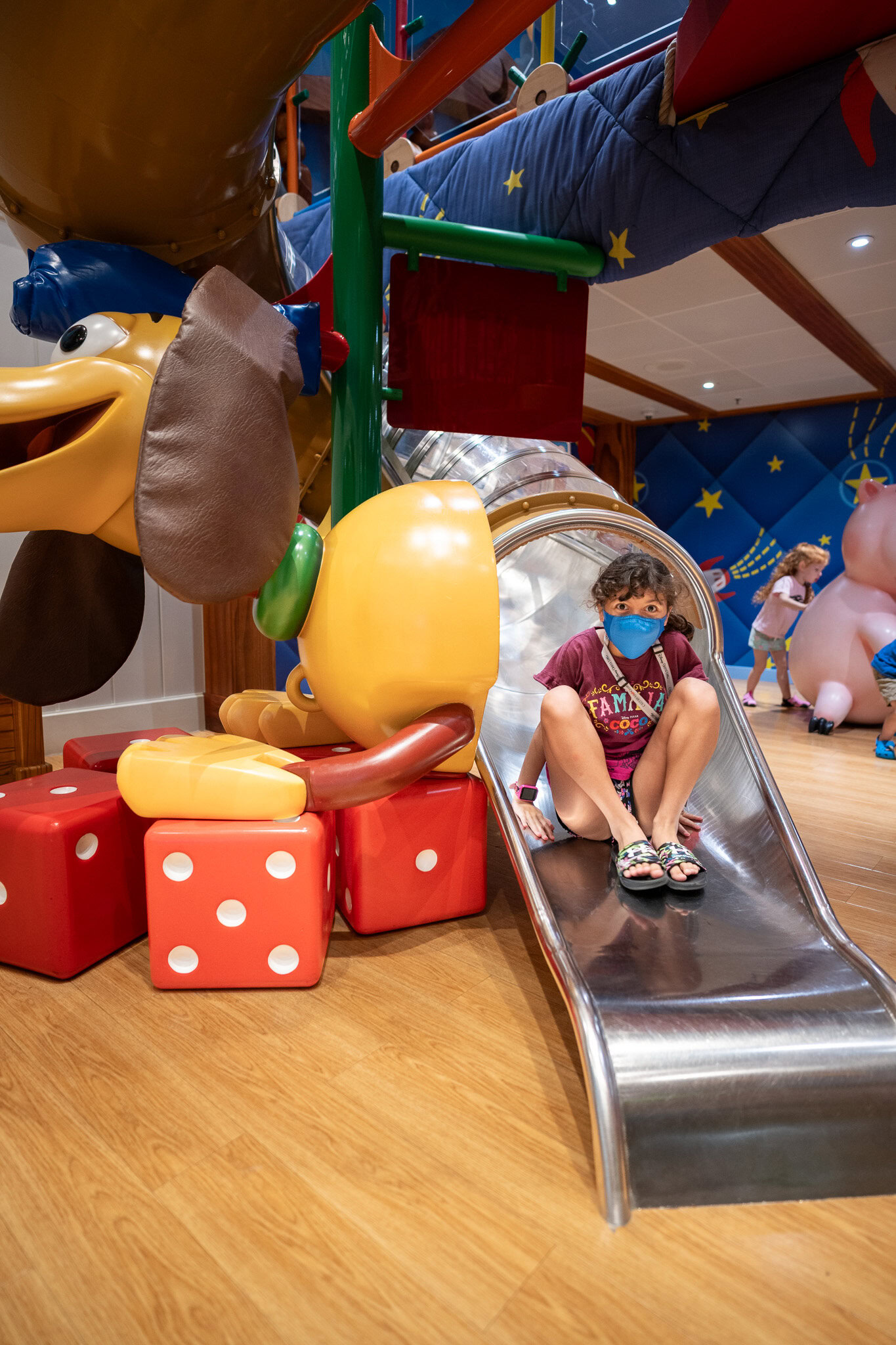 Girl on Slinky Dog slide at Kids Club on Disney Magic