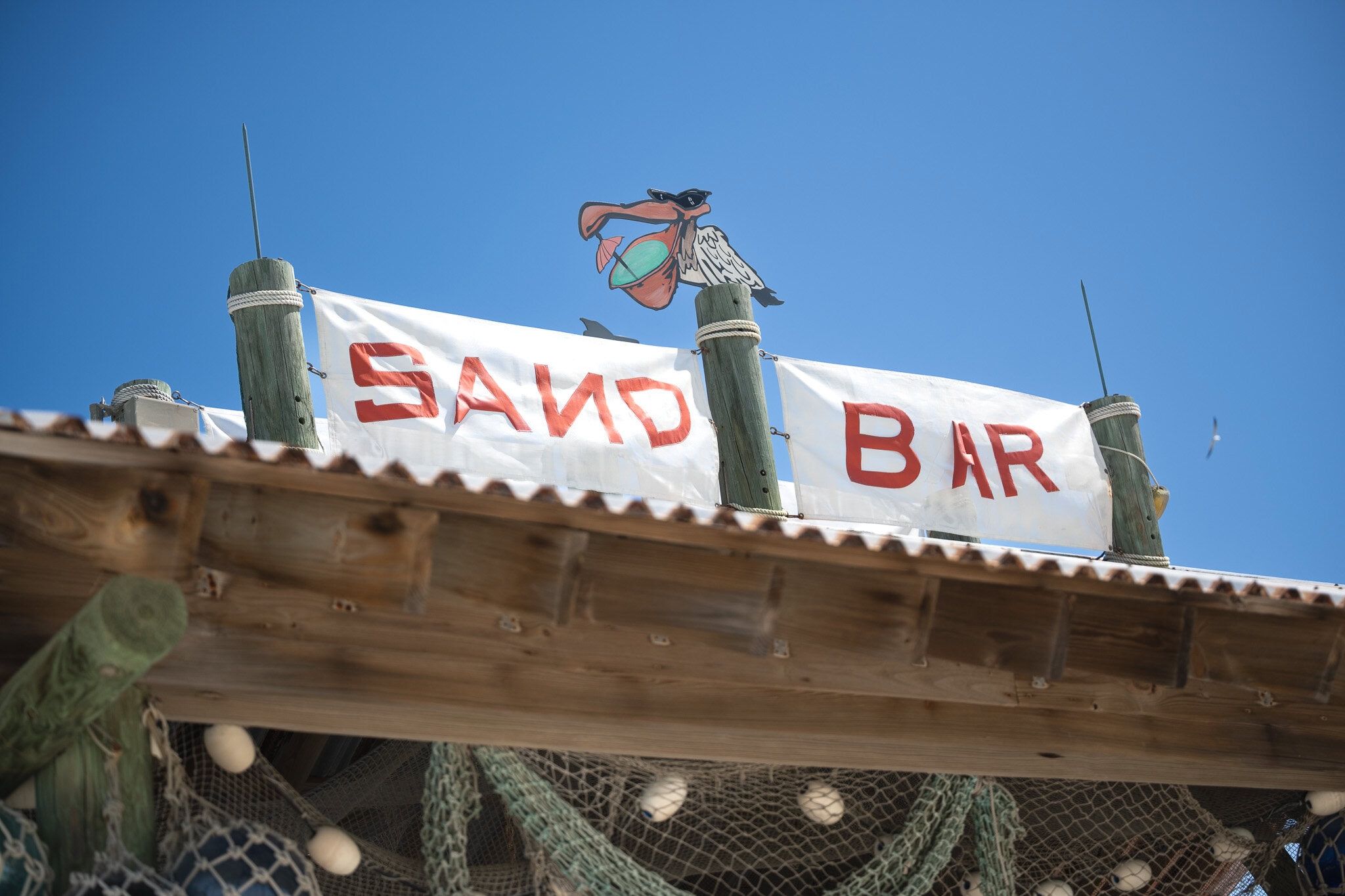 Sand Bar sign at Castaway Cay with blue skies