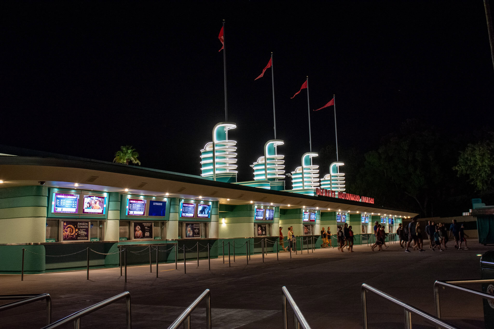 Disney's Hollywood Studios entrance illuminated at night.