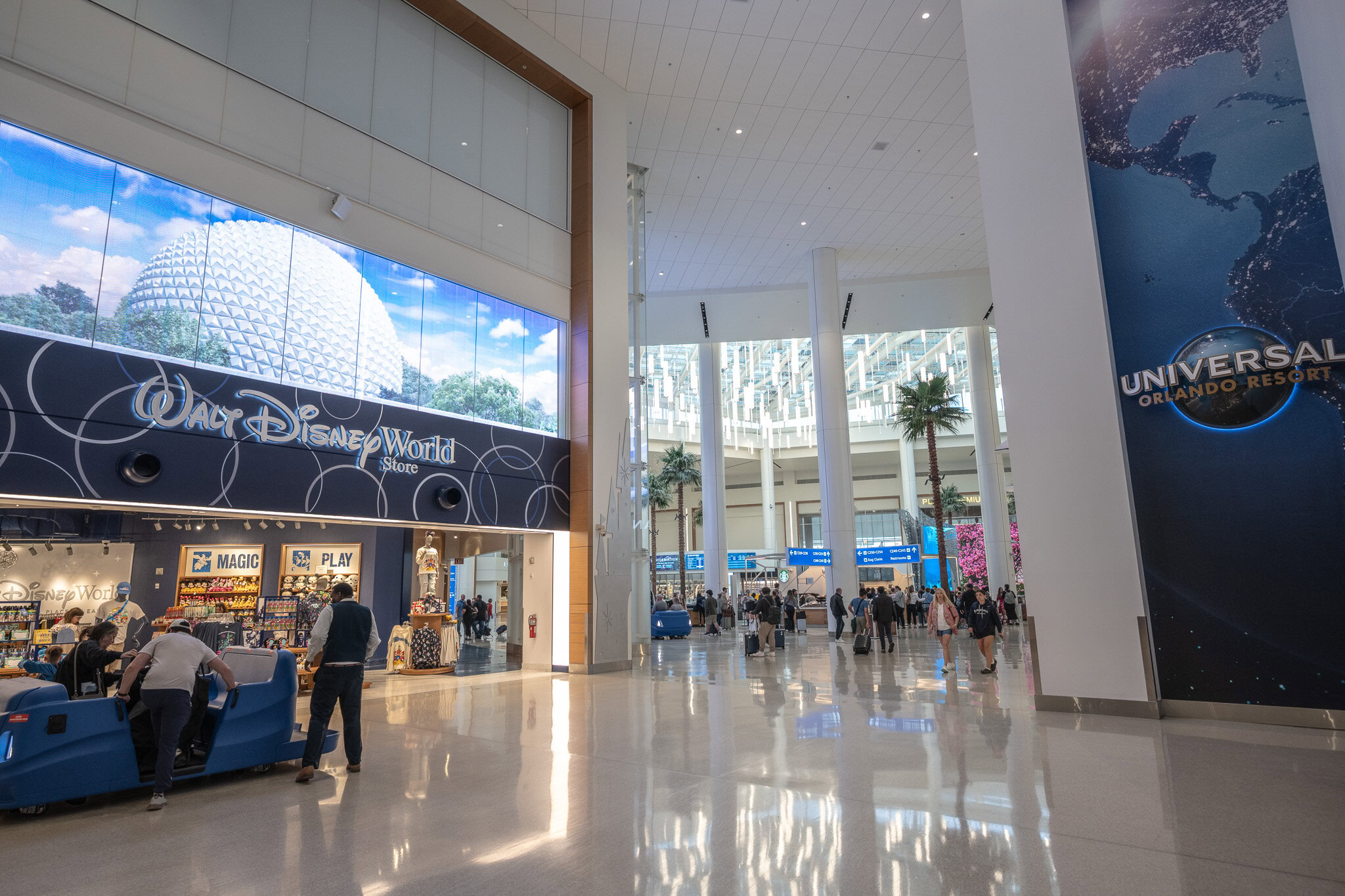 Orlando International Airport Terminal C featuring Disney and Universal storefronts