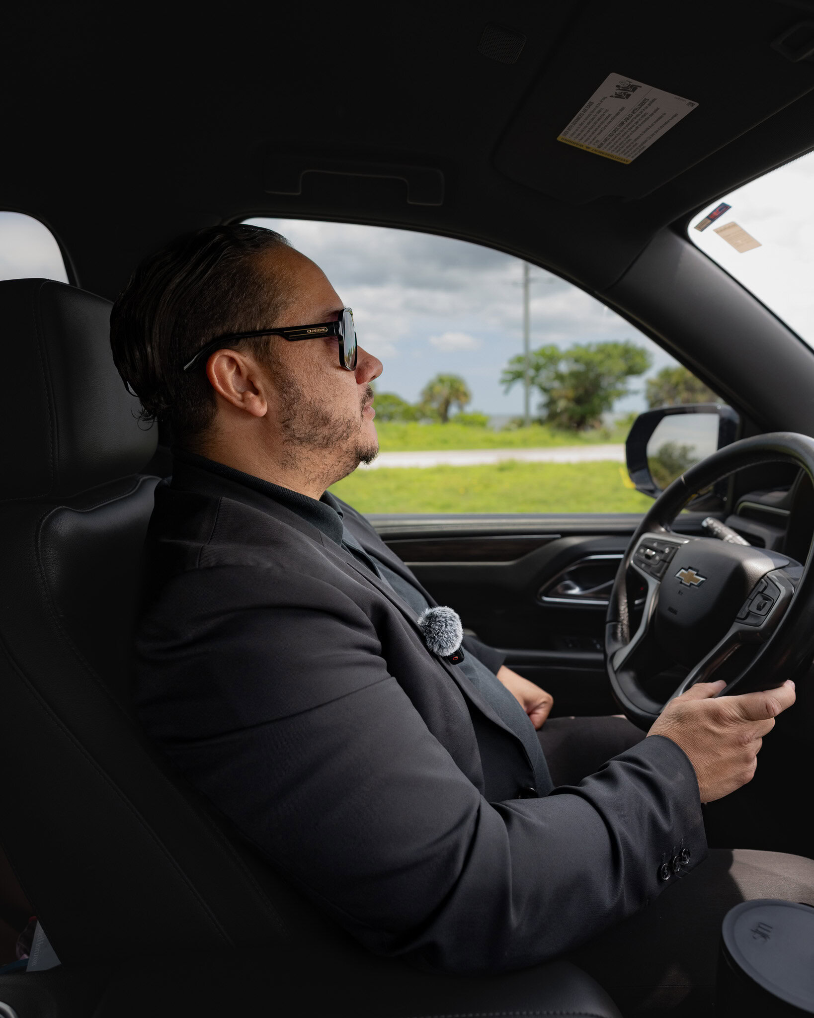 Rafael Green, owner of Gem Luxury Services, driving a Chevrolet SUV in Orlando