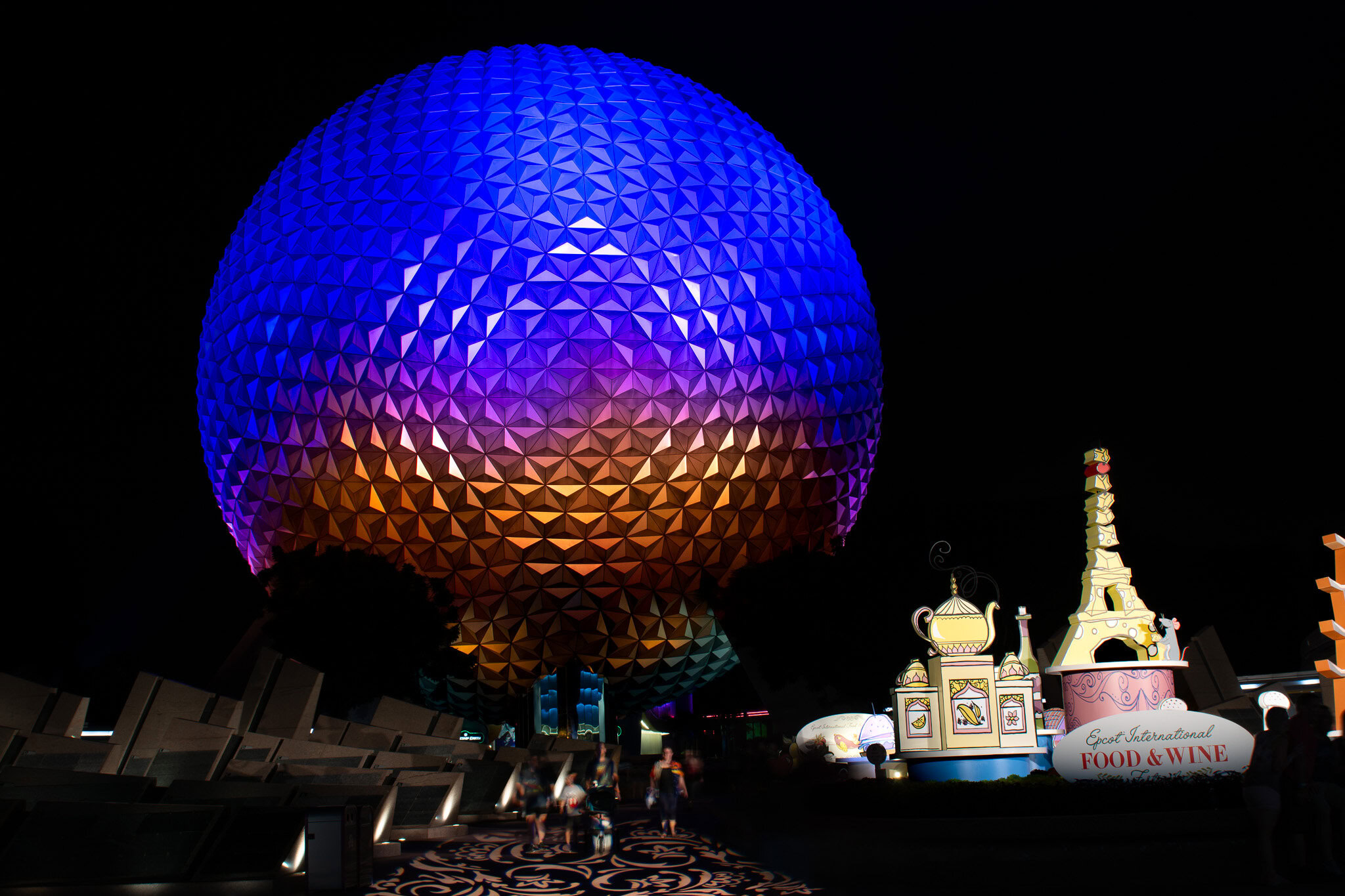 Spaceship Earth illuminated at night during the EPCOT International Food & Wine Festival.