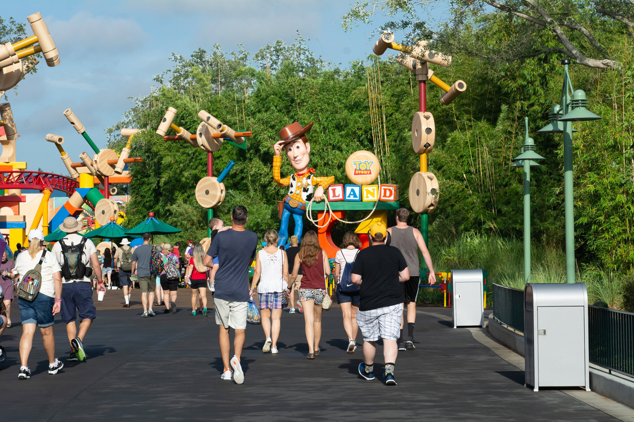 Guests entering Toy Story Land beneath the Woody entrance at Disney's Hollywood Studios.