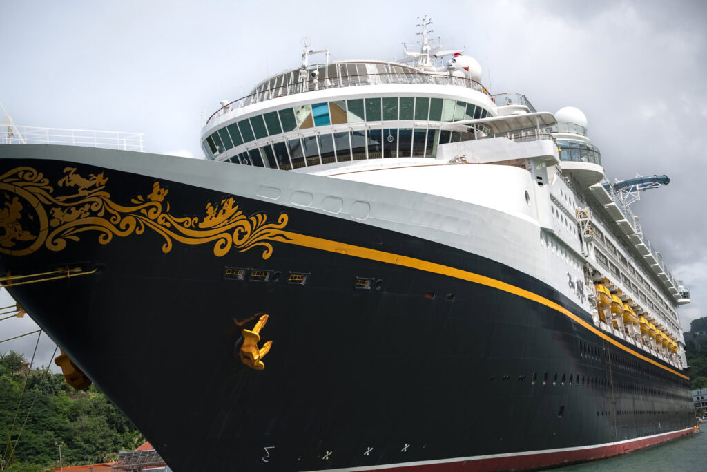 Close-up of the Disney Magic cruise ship docked in St. Lucia, photographed from a catamaran during a Southern Caribbean itinerary.