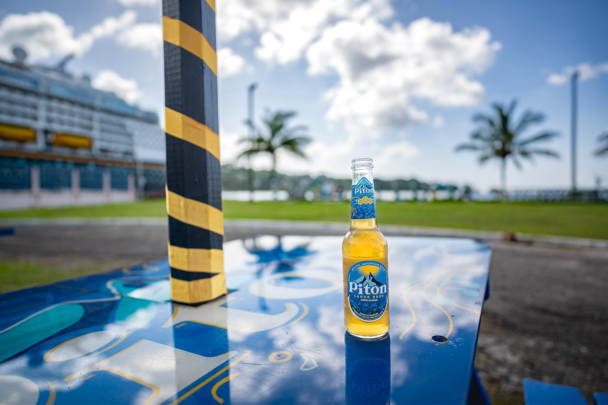 Piton beer enjoyed near the St. Lucia cruise port with Disney Magic in the background