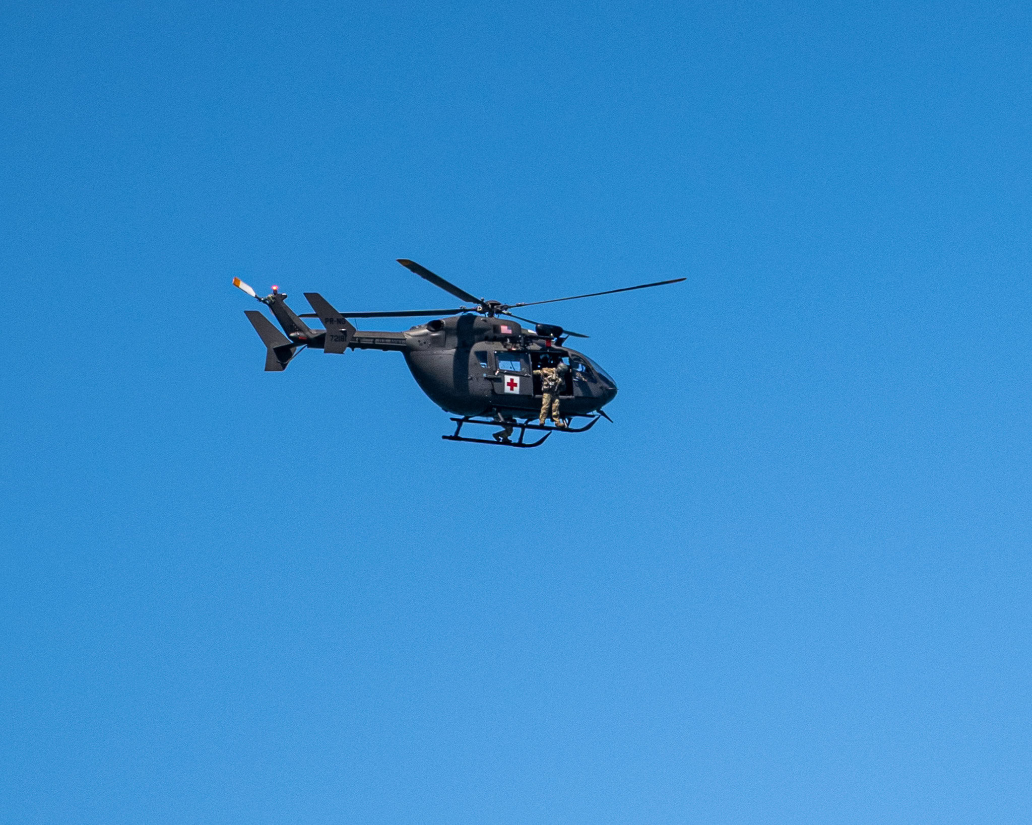 Puerto Rico National Guard helicopter conducting a search operation near Condado Beach in San Juan after a swimmer was taken by a strong current.
