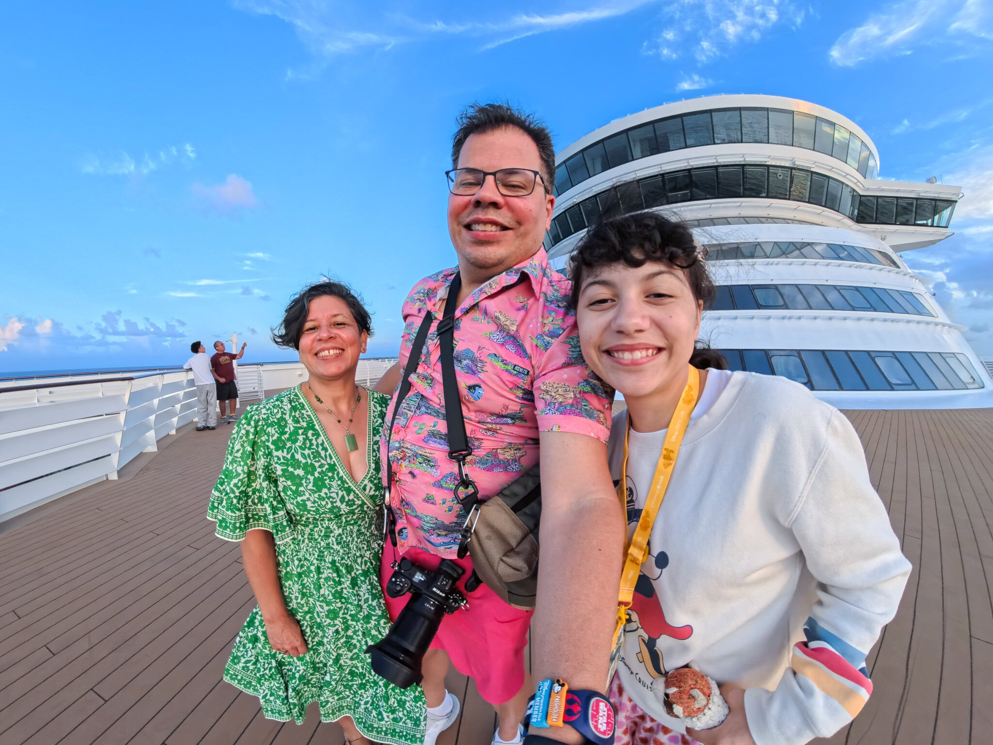 Raúl, Lucy, and Daniela smiling on the Disney Wish deck during Nassau port day