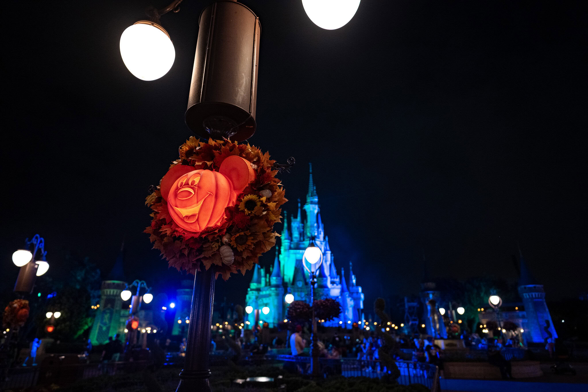 Mickey pumpkin wreath and Cinderella Castle at night during MNSSHP