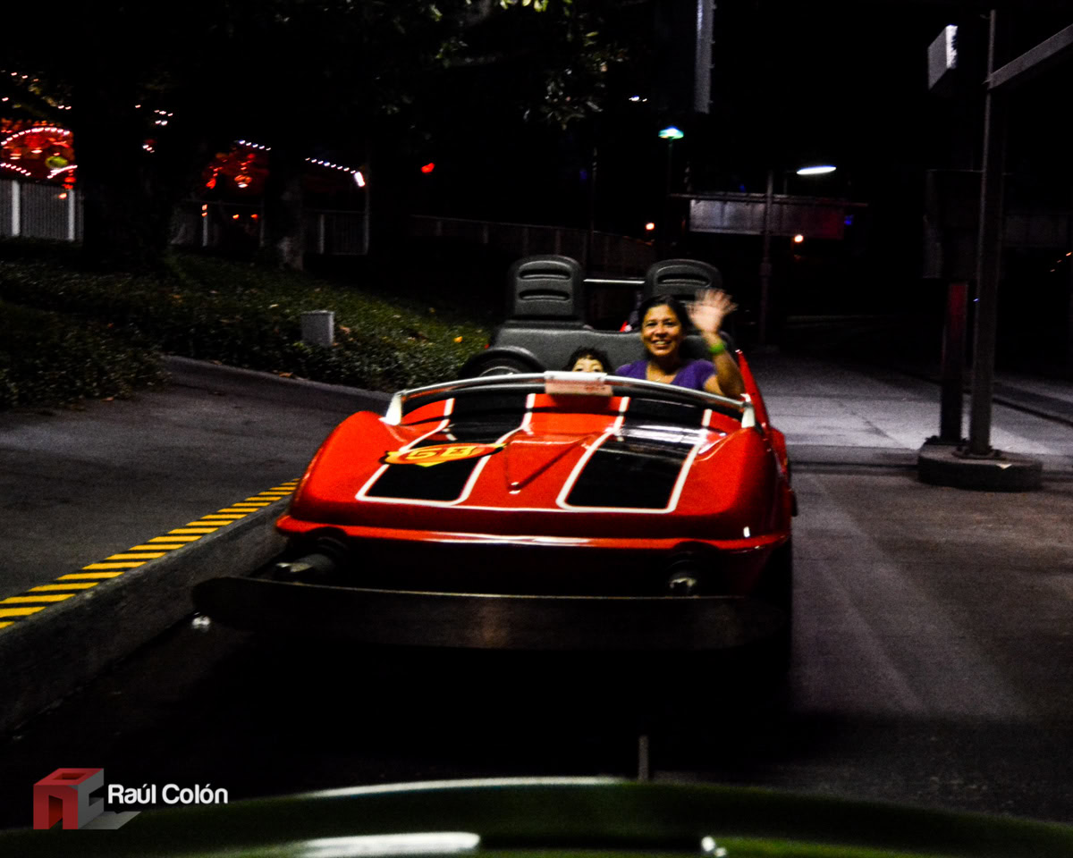 Mom and young daughter riding Tomorrowland Speedway at Magic Kingdom at night in 2014