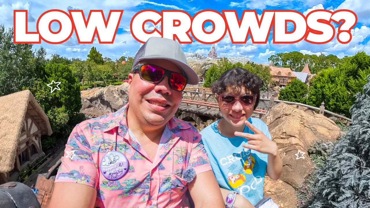 Raúl and his daughter at Magic Kingdom near Seven Dwarfs Mine Train with Cinderella Castle in the background discussing Magic Kingdom party day crowds.