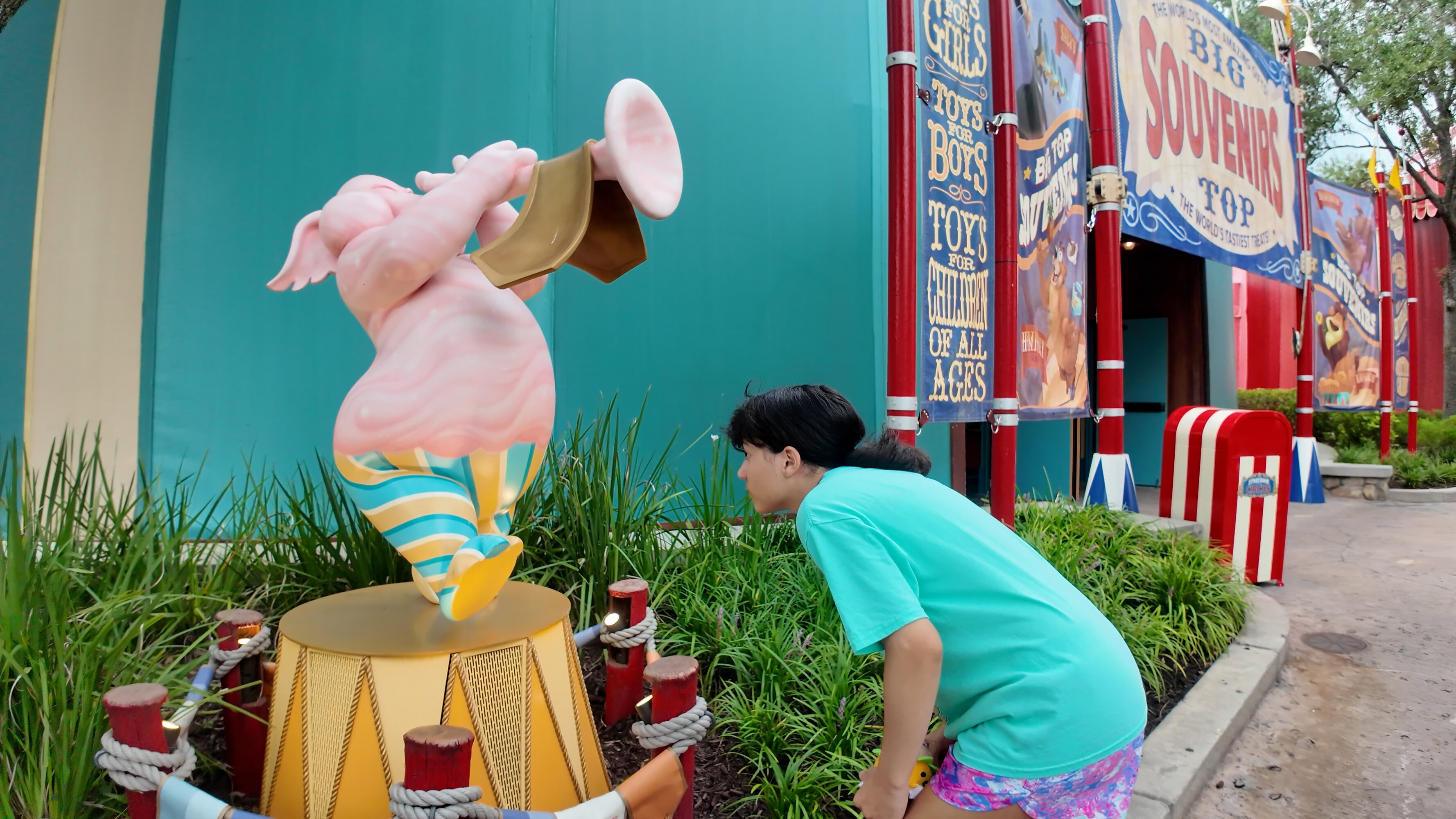 Daniela smelling a scent station at Smellephants on Parade in Magic Kingdom