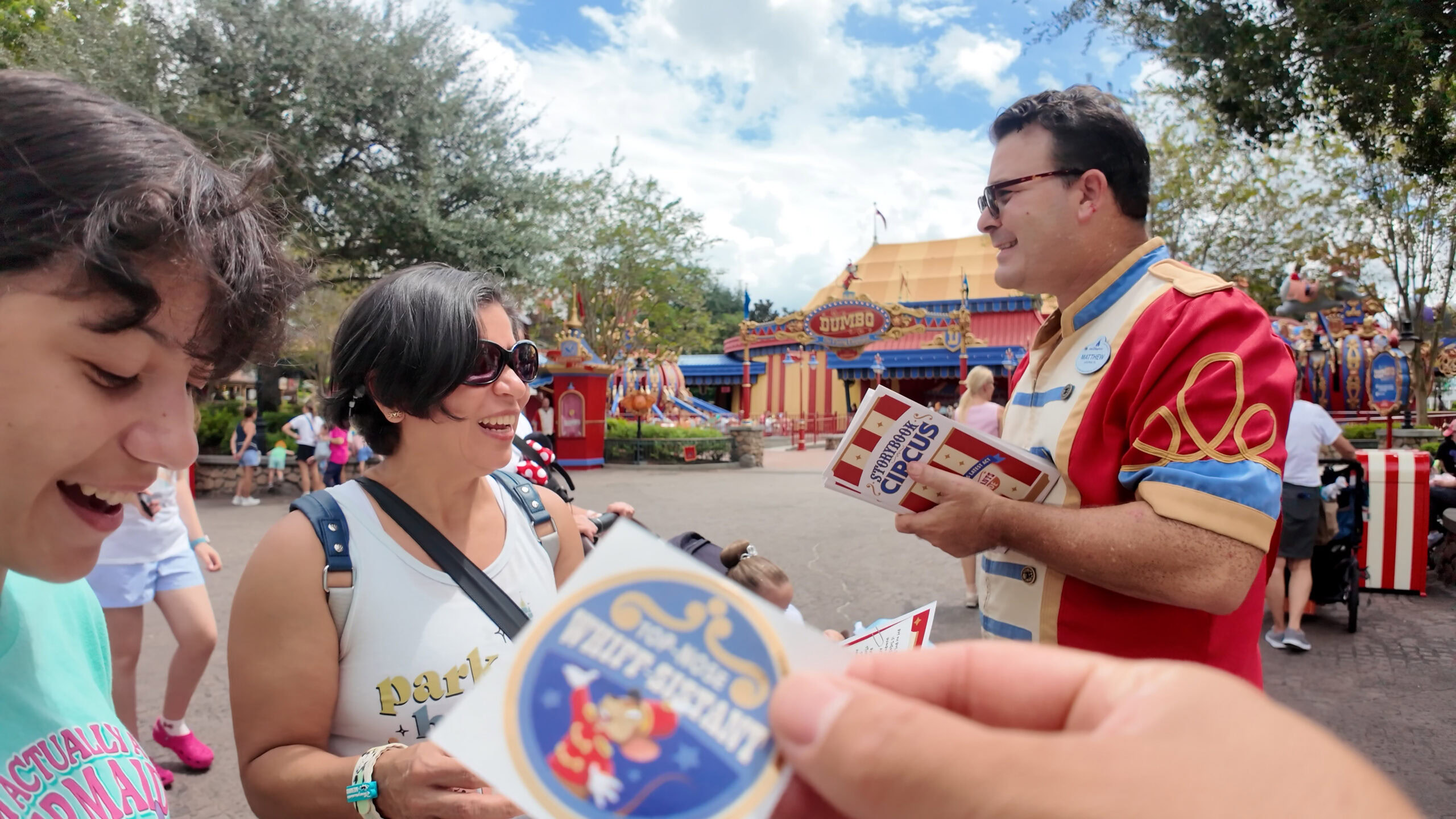 Cast member handing out Smellephants on Parade activity materials in Magic Kingdom