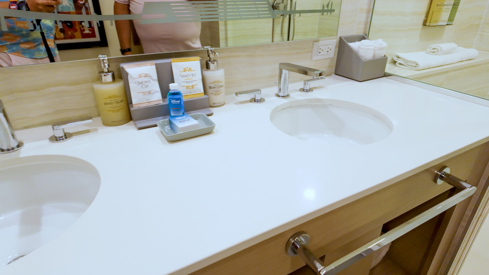 Double-sink bathroom vanity with Disney bath amenities in a Contemporary Resort Garden Wing room.