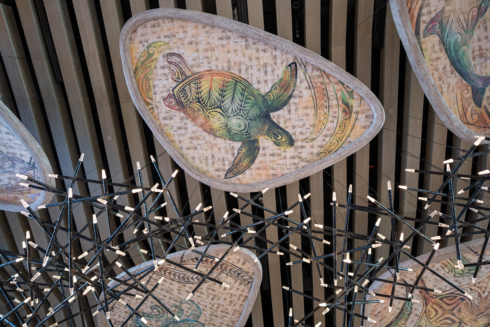 Sea turtle artwork and hanging lights inside Disney&rsquo;s Polynesian Island Tower lobby.
