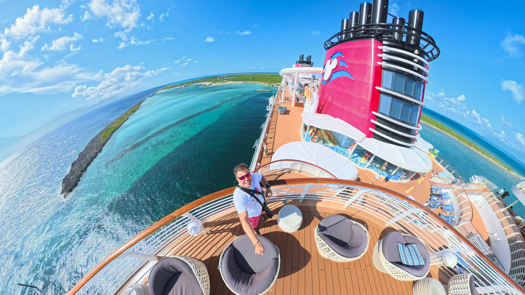 Disney Wish Selfie by Raúl at Castaway Cay View Raúl taking a 360 selfie on the Disney Wish deck with Castaway Cay and turquoise Caribbean waters in the background.