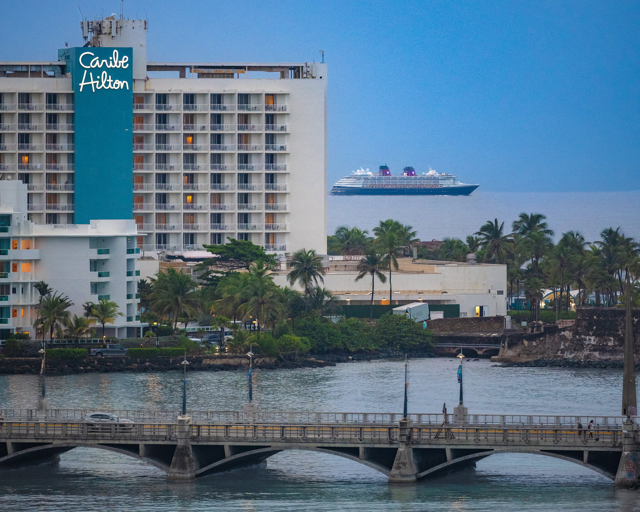 Disney Magic cruise ship sailing past Caribe Hilton along the San Juan waterfront in Puerto Rico.