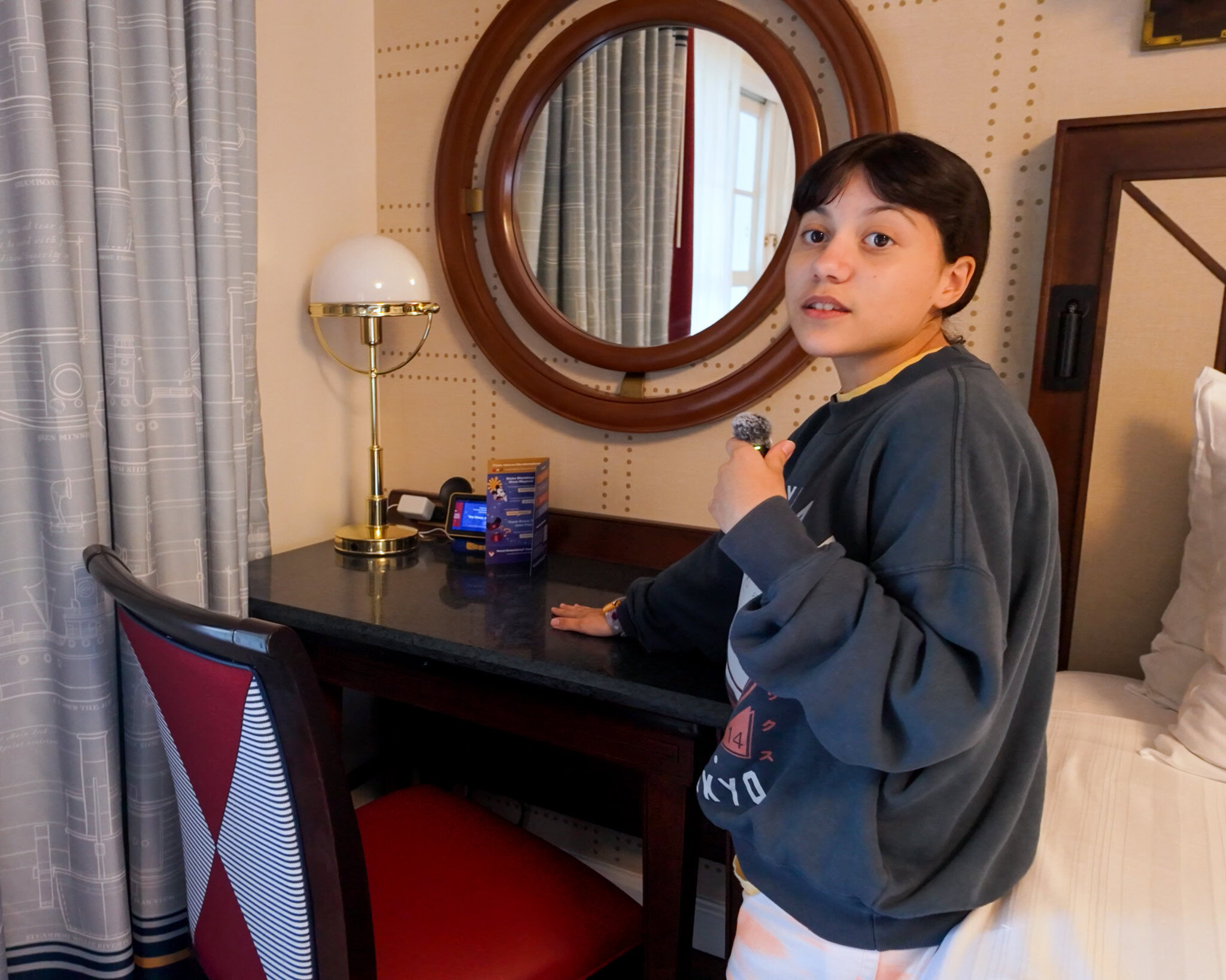Pull-out desk and nautical decor inside a Disney’s Yacht Club Resort room