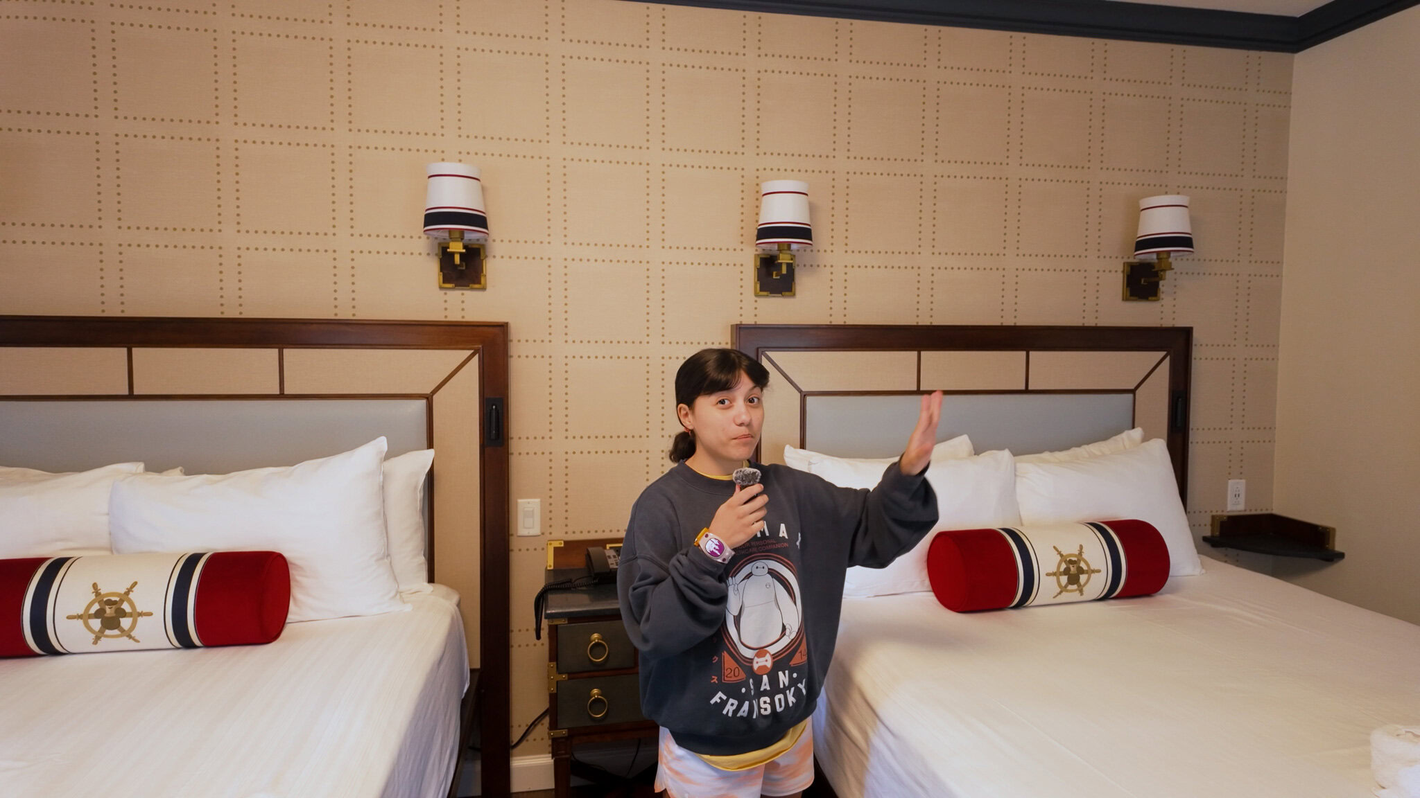 Two queen beds with nautical decor in a Disney’s Yacht Club Resort room
