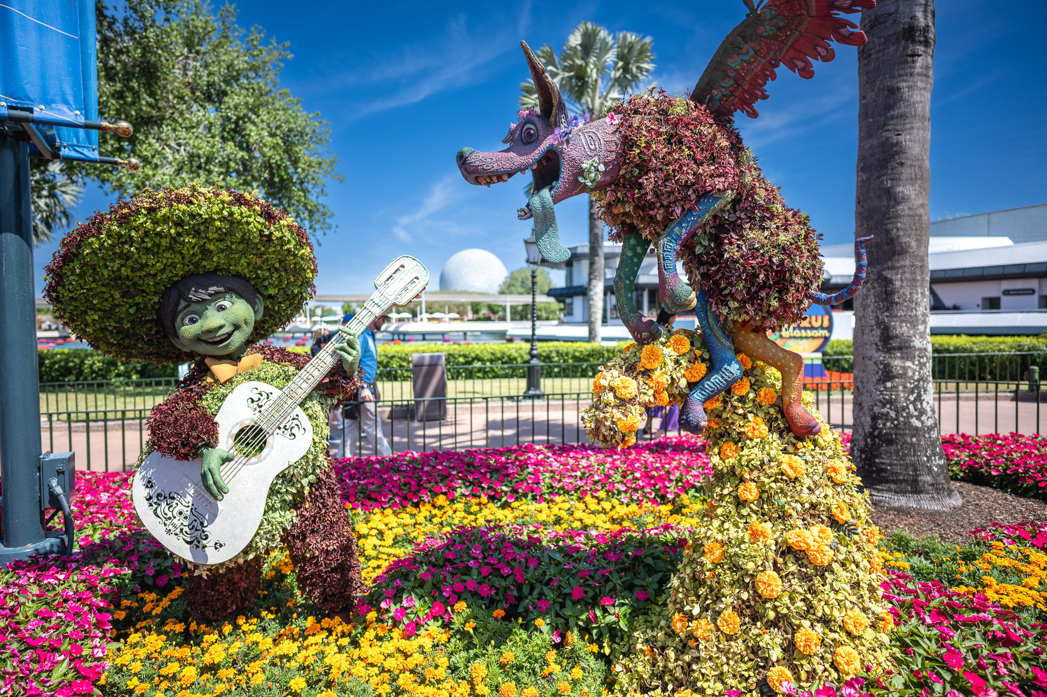 Coco Topiary at Epcot Flower and Garden Festival A playful view of the Alien Swirling Saucers ride at Toy Story Land in Hollywood Studios, featuring the green alien in his spacecraft.