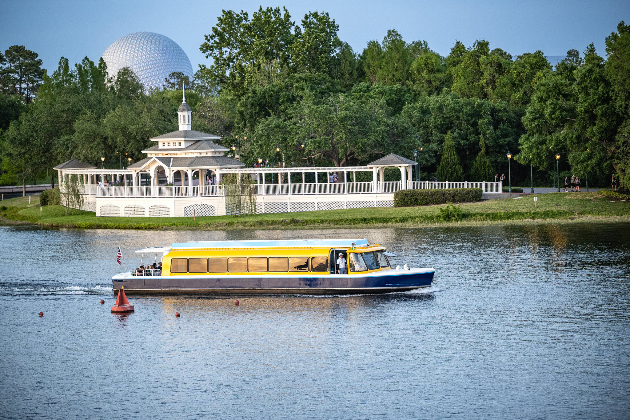 Friendship Boat Near Epcot at Disney World Friendship boat cruising across Crescent Lake with Epcot's Spaceship Earth in the background
