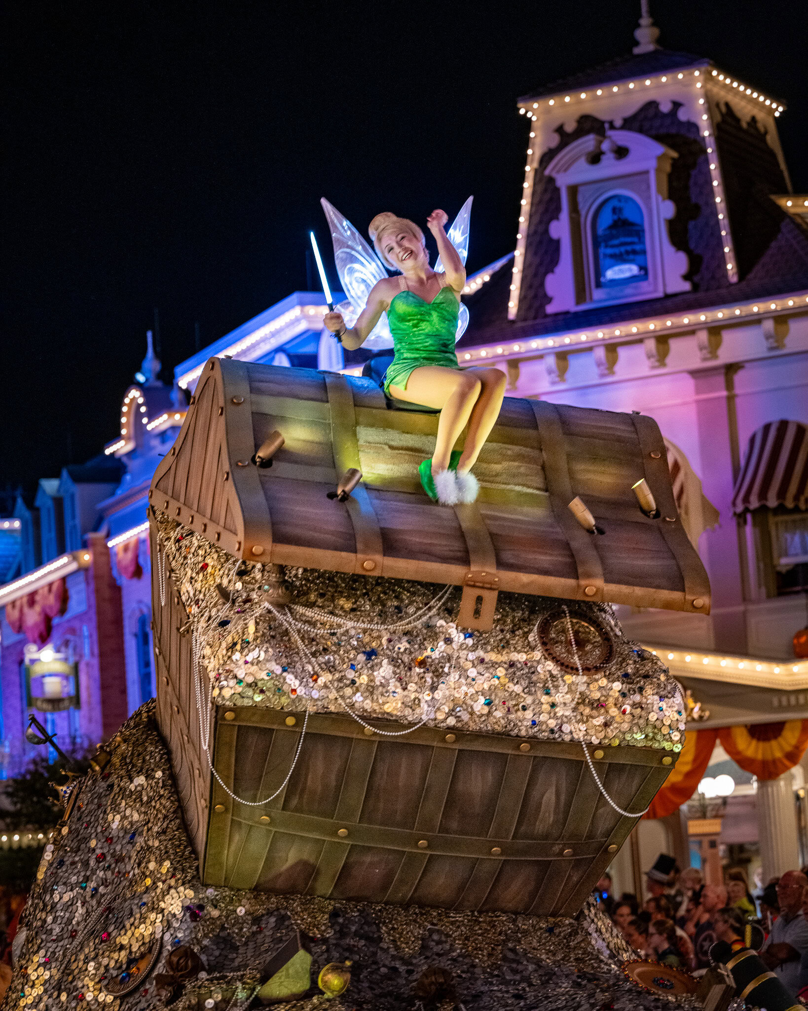 Tinker Bell on Parade Float Tinker Bell waving from a treasure chest float during Mickey’s Not-So-Scary Halloween Party