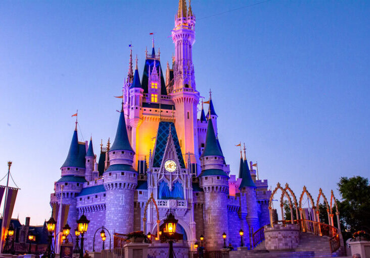 Cinderella Castle illuminated at twilight in Walt Disney World