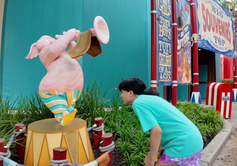 Daniela smelling a scent station at Smellephants on Parade in Magic Kingdom