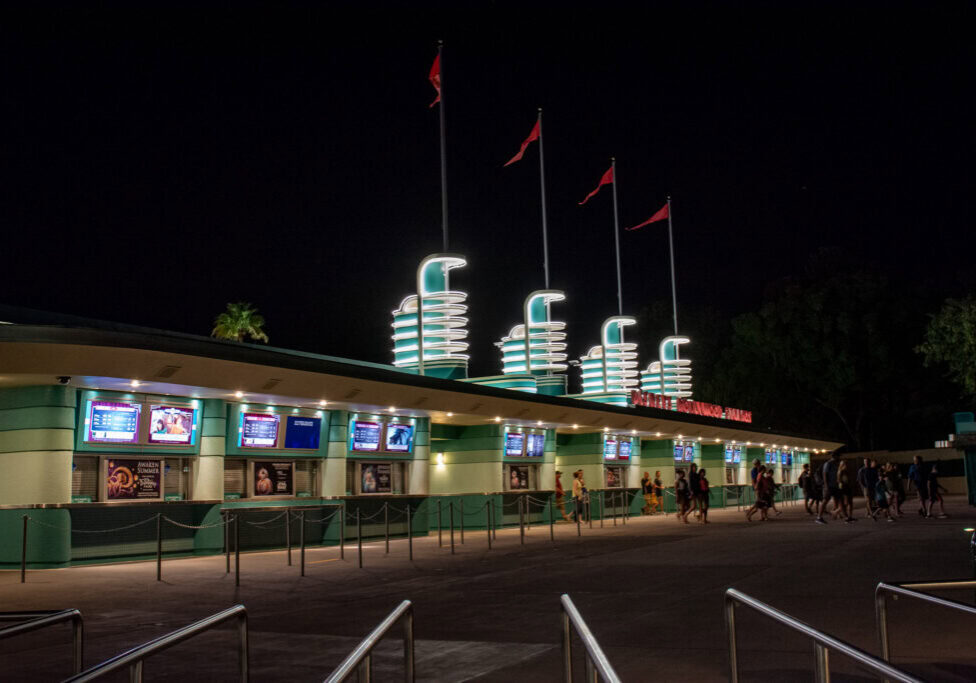 Disney's Hollywood Studios entrance illuminated at night.