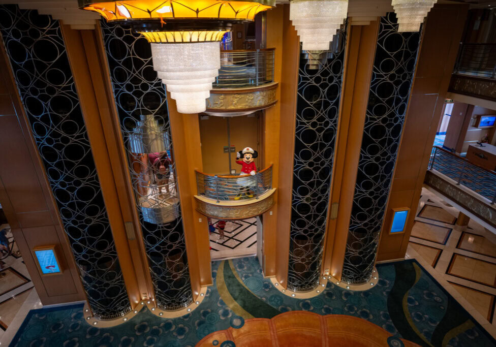 Captain Minnie waving from a balcony on Disney Magic