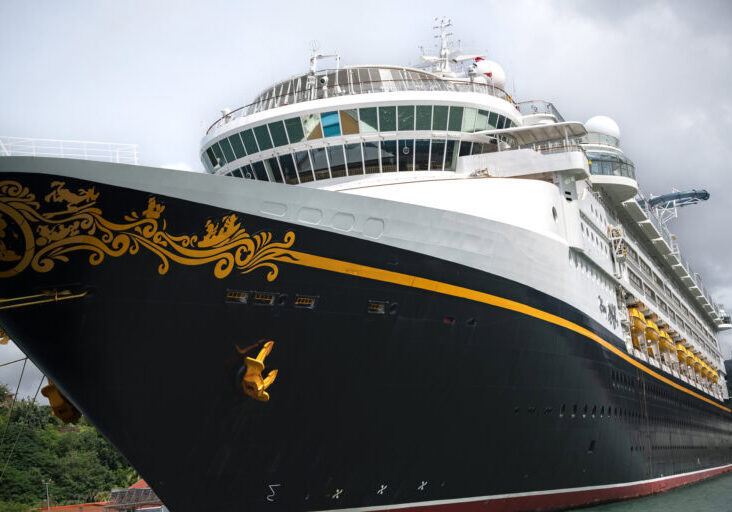 Close-up of the Disney Magic cruise ship docked in St. Lucia, photographed from a catamaran during a Southern Caribbean itinerary.