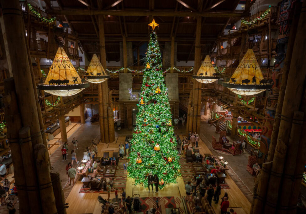 Disney’s Wilderness Lodge grand lobby with towering Christmas tree and holiday decor viewed from above