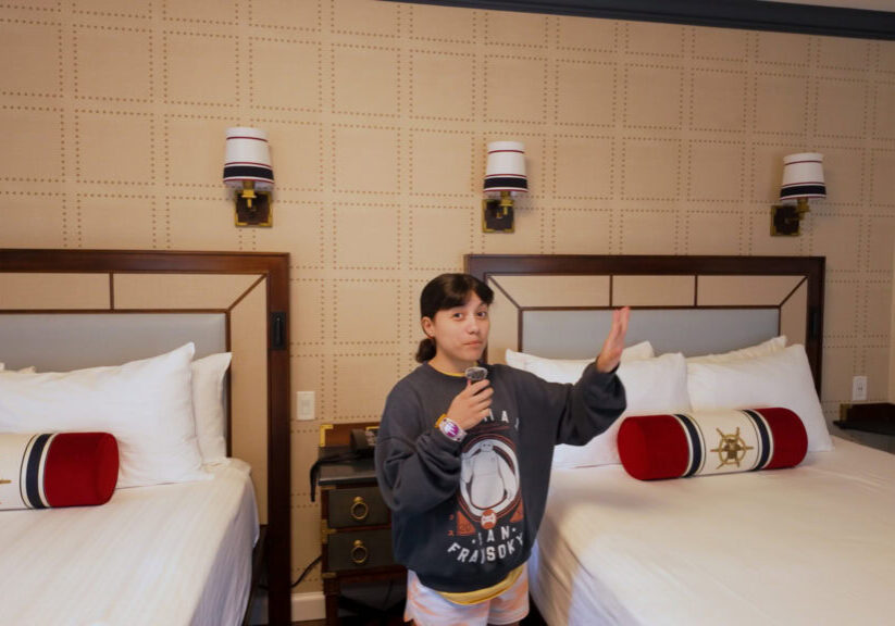 Two queen beds with nautical decor in a Disney&rsquo;s Yacht Club Resort room