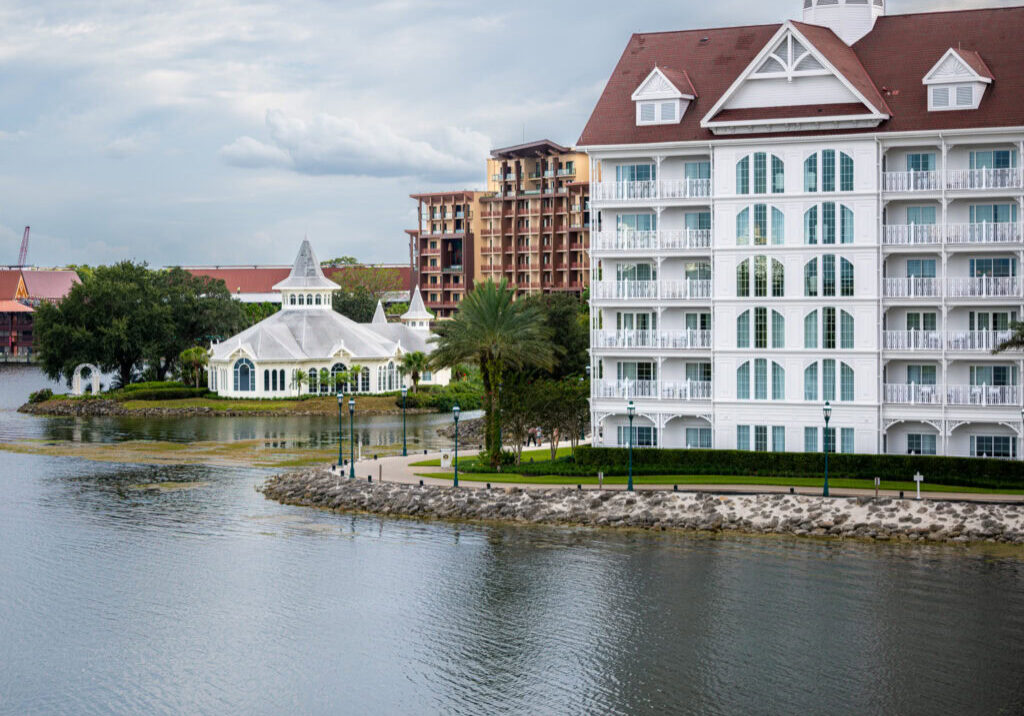 Disney&rsquo;s Grand Floridian Resort and Polynesian Island Tower viewed across Seven Seas Lagoon.