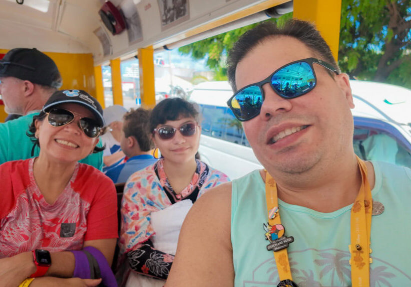 Lucy, Daniela, and Raúl riding a tram to Harbour Lights Beach in Barbados during a Disney Cruise port day.