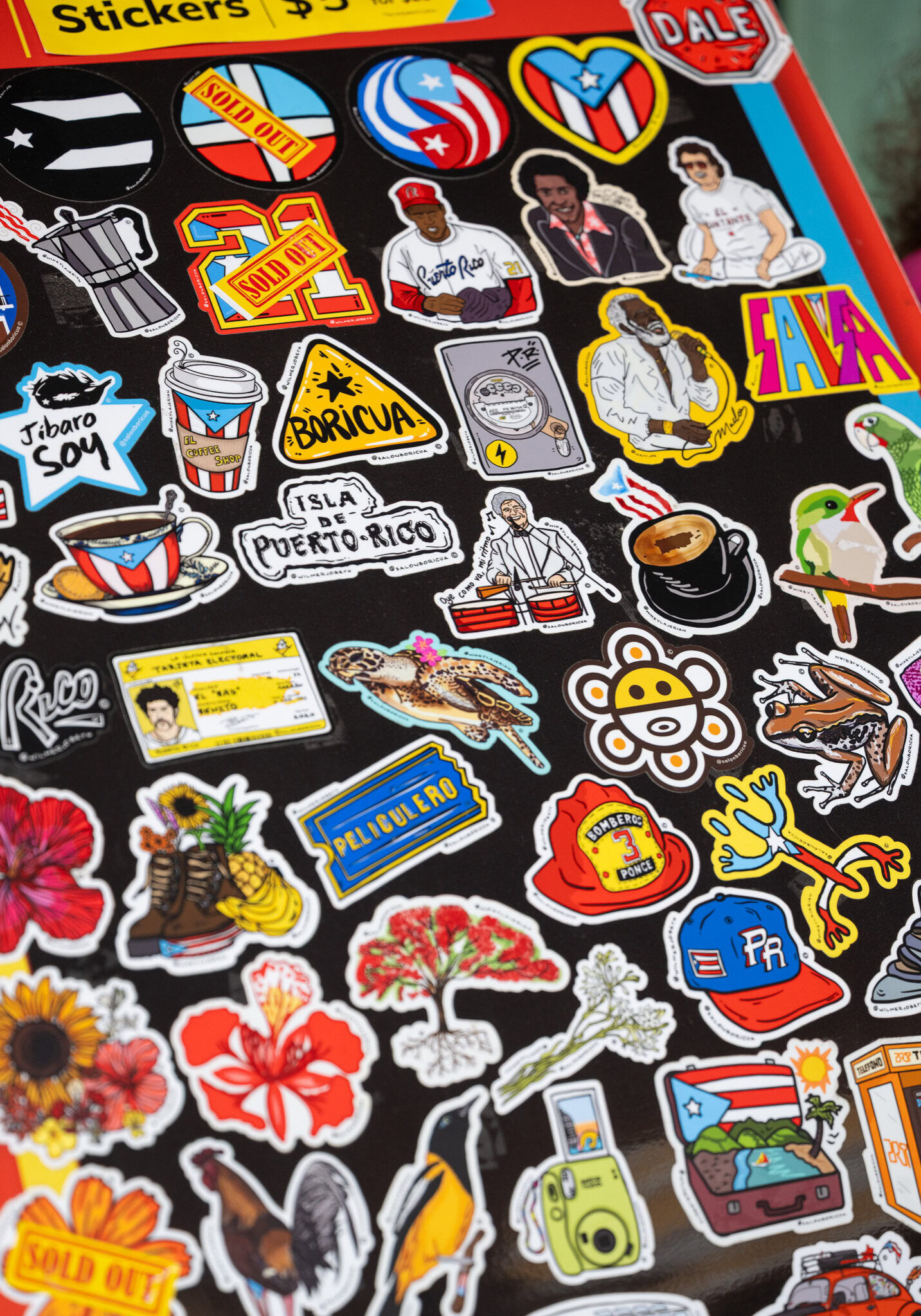 Sticker sheet with Puerto Rican cultural designs from Salon Boricua, including flags, coffee cups, tropical flowers, and coquí frogs.