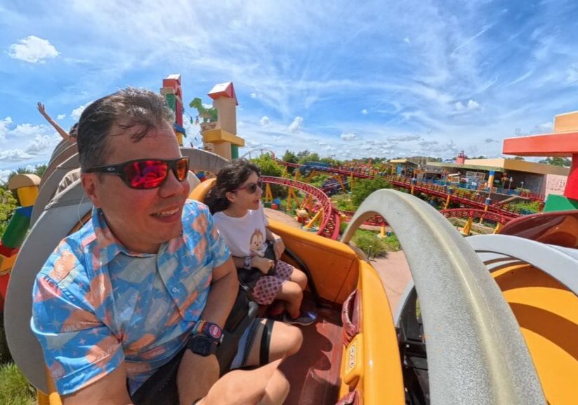Dad and young daughter riding Slinky Dog Dash roller coaster at Disney’s Hollywood Studios