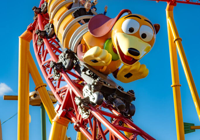 Slinky Dog Dash roller coaster at Disney's Hollywood Studios, captured mid-ride on a sunny day.
