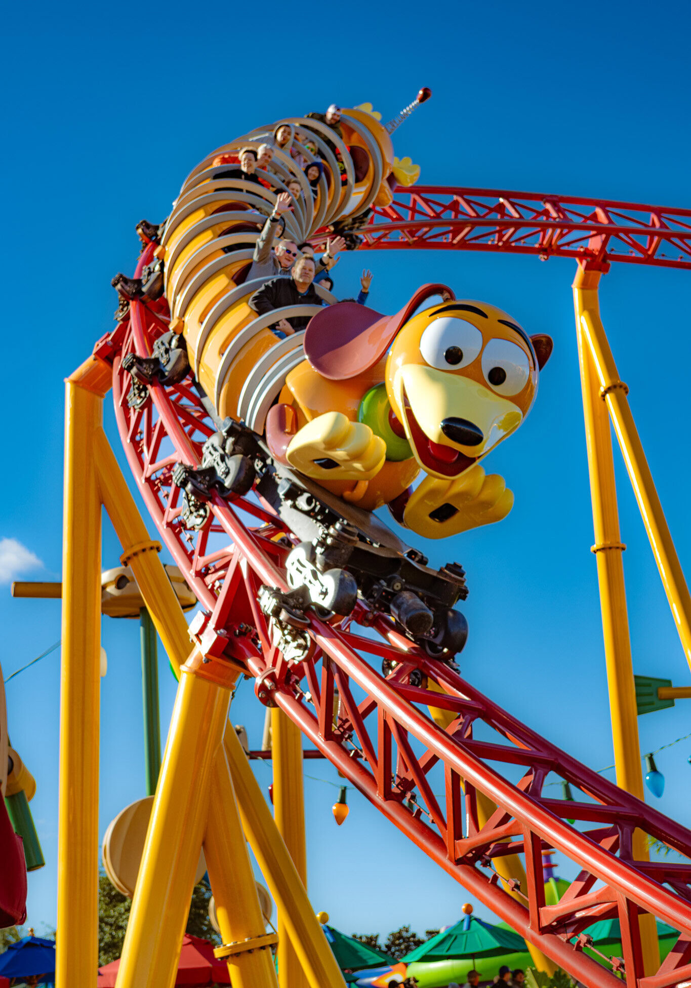 Slinky Dog Dash roller coaster at Disney's Hollywood Studios, captured mid-ride on a sunny day.